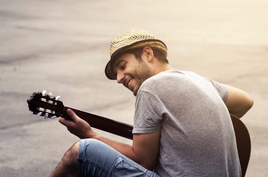 Man playing guitar on the street. retro style.