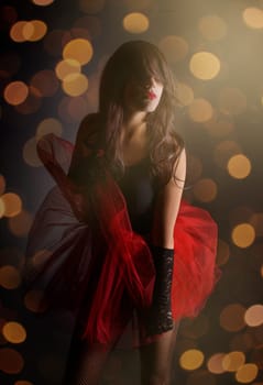 Beautiful female dancer in front of night lights