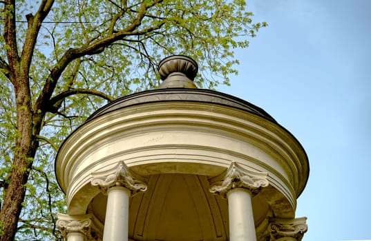rococo architecture, roof of a little white temple next to a tree, worms eye view