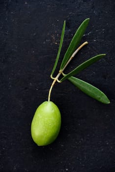 Fresh olive on black rustic background