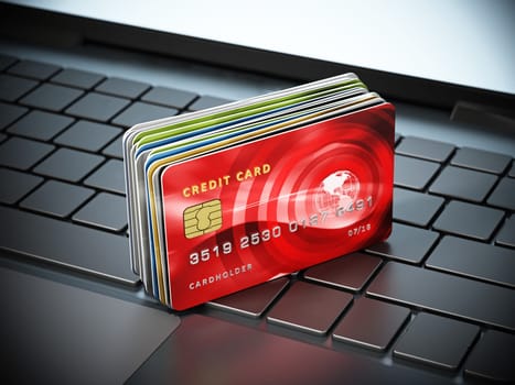 Credit cards standing on laptop computer keyboard. 3D illustration.