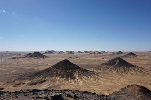 Pitch black hills of the black dessert on a tour to black and white desert, Egypt