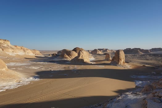Long shades of rock formations in the white desert, Egypt
