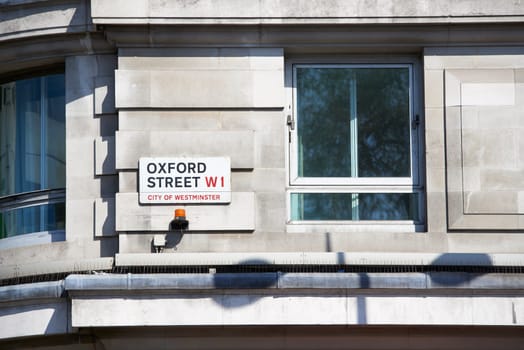 Detail of Oxford Street sign next to an empty window.