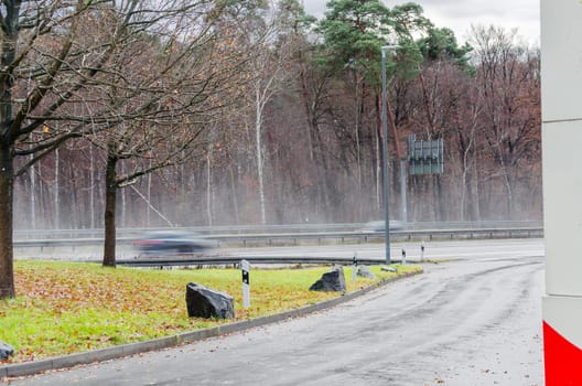 View from a parking lot to a highway in heavy rain.