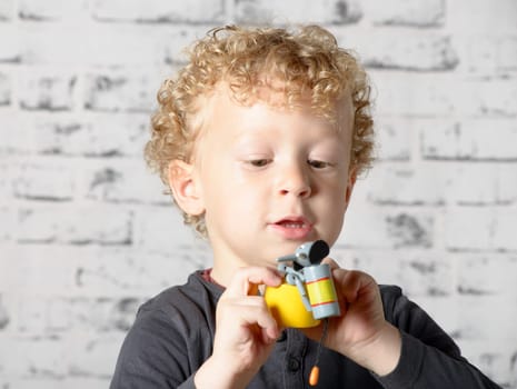a little child plays with toys animals