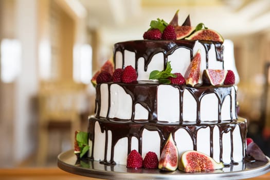 Chocolate cake with figs and raspberries close-up