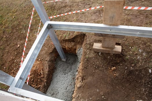 Foundation with cement in the metal construction of a balcony