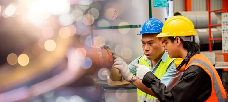 Two workers man talking working in factory, male supervisor talking with engineers for maintenance and inspection machinery at industry manufacturing