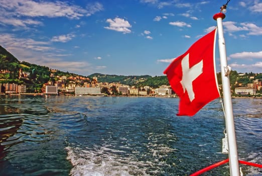 Boat with flag on Lake Lugano, Switzeland