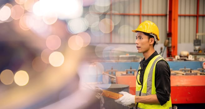 Worker man hand push remote control switch for overhead crane in factory, technician operating controlling the lift at factory industrial warehouse