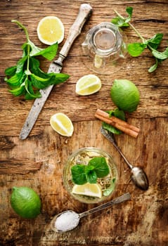 Mojito ingredients on rustic wooden background