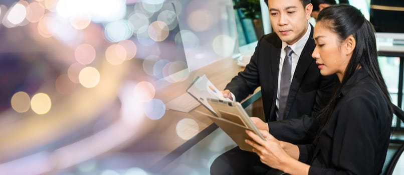Two business people having meeting together discussing the charts and graphs showing the results, Asian business teamwork talking and analysis budget cost graph of their successful on desk office