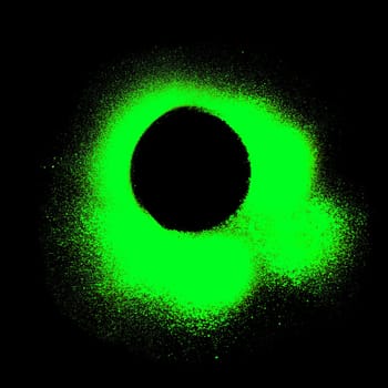 Light green paintbrush or graffiti circle on black background