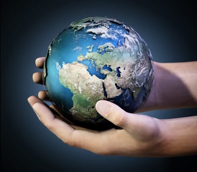 Hands holding a globe against dark background. 3D illustration.