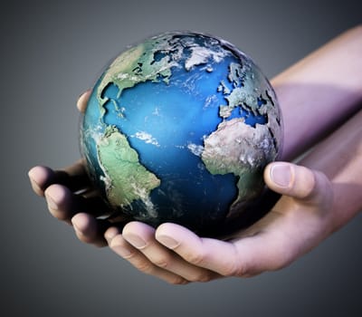 Hands holding a globe against dark background. 3D illustration.