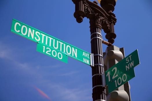 Green 10 Street North West historic sign in downtown Washington D.C. at the intersection with Constitution North West Avenue, numbers 400 and 1200