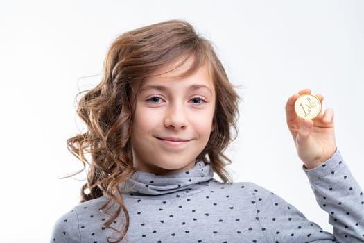 Little girl holding up a one Euro coin with a pleased happy smile in a close up portrait isolated on white