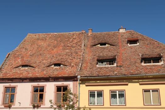 Houses in Sibiu with their typical roof windows, shaped like eyes, Romania 2021