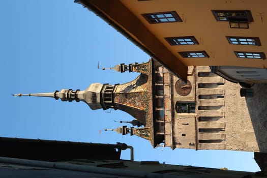 Glimpse on Sighisoaras famous Clock Tower from inside of the Citadel at Golden hour, Romania 2021