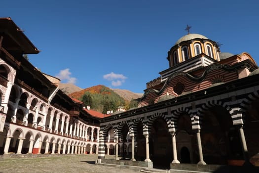 Inside Rila Monastery, the famous Main Church in the front and the woods in the background, Bulgaria 2021