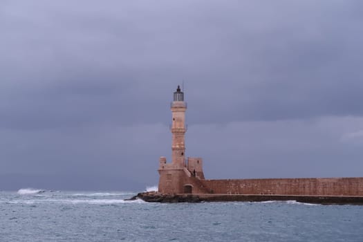 Chania's lighthouse resisting the rough sea in fall, Crete, Greece 2021