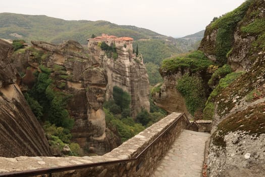 Amazing view from the stairs leading up to the Holy Monastery of Great Meteoron onto the Monastery of Varlaam, Meteora, Greece 2021