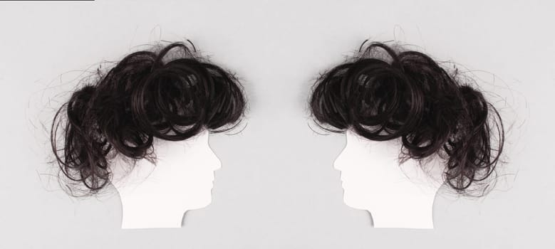 Silhouette of two faces with hair looking to each other, communication, having an opinion and discussion, free speech, people talking