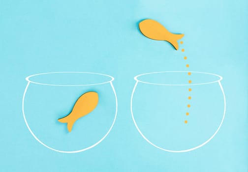 One fish is the leader of the group, leadership and teamwork concept, be a winner, success and start up in business, follow a new idea, fishes in a aquarium jump to freedom