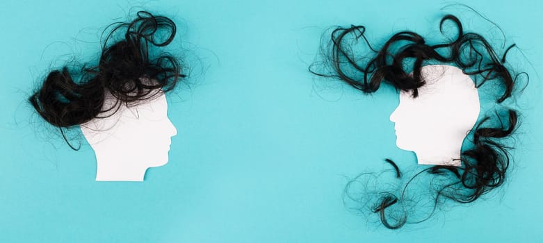 Silhouette of two faces with hair looking to each other, communication, having an opinion and discussion, free speech, people talking