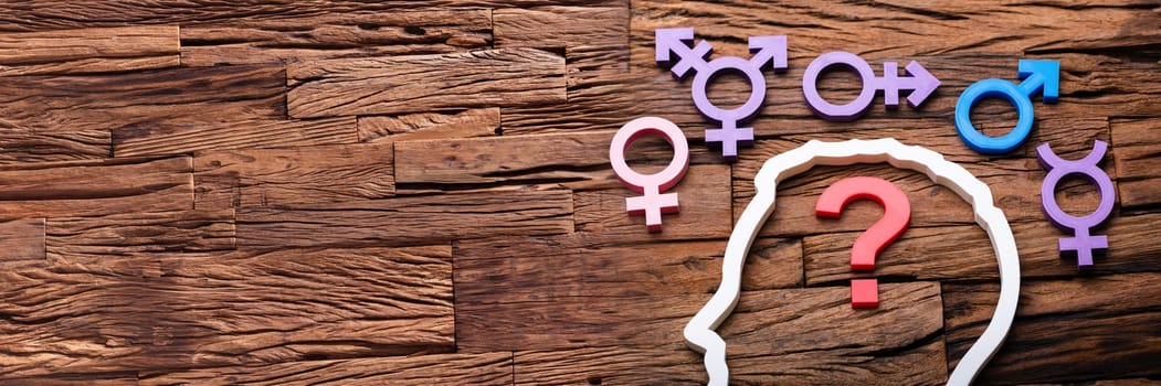 Question Mark Inside Persons Head Outline And Multiple Gender Signs Around