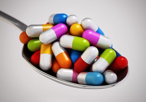 Multi colored vitamin pills inside a metal spoon. 3D illustration.