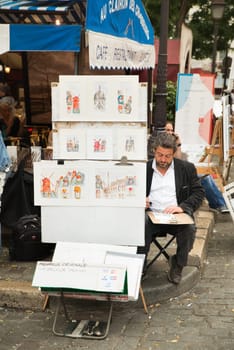 Montmartre Paris, painter at the place du tertre, tourism attraction in France, artists drawing portraits, Paris at the Montmartre on the 04.08.2017