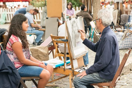Montmartre Paris, painter at the place du tertre, tourism attraction in France, artists drawing portraits, Paris at the Montmartre on the 04.08.2017