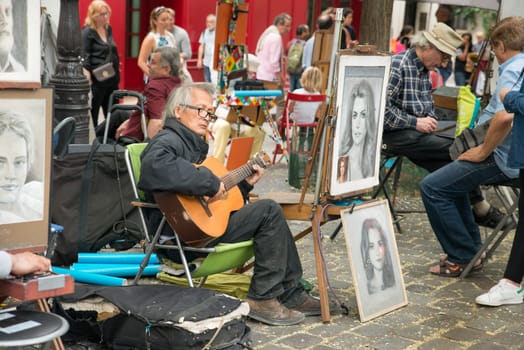 Montmartre Paris, painter at the place du tertre, tourism attraction in France, artists drawing portraits, Paris at the Montmartre on the 04.08.2017
