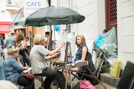 Montmartre Paris, painter at the place du tertre, tourism attraction in France, artists drawing portraits, Paris at the Montmartre on the 04.08.2017
