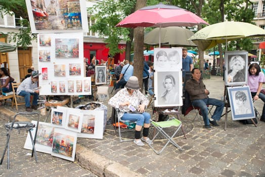 Montmartre Paris, painter at the place du tertre, tourism attraction in France, artists drawing portraits, Paris at the Montmartre on the 04.08.2017