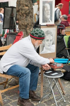 Montmartre Paris, painter at the place du tertre, tourism attraction in France, artists drawing portraits, Paris at the Montmartre on the 04.08.2017