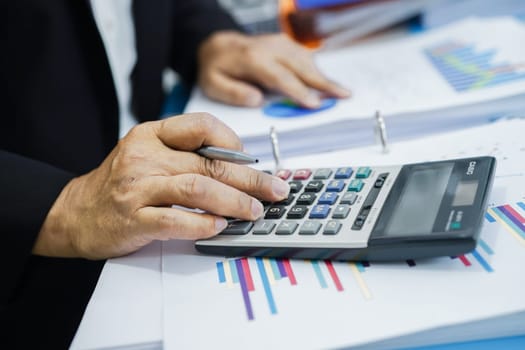 Businessman working and analysis with statistic graph in office.