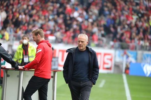Coach Christian Streich (Freiburg) on the way to the TV interview before the match of the 1st FBL: 21-22: 31st Sptg. SC Freiburg vs Borussia Mönchengladbach... DFL REGULATIONS PROHIBIT ANY USE OF PHOTOGRAPHS AS IMAGE SEQUENCES AND/OR QUASI-VIDEONann.. Photo: Joachim Hahne/johapress