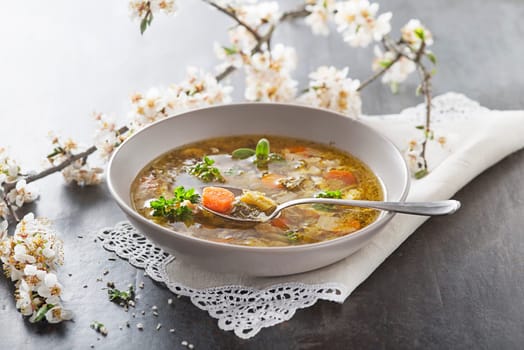 Minestrone soup with fresh vegetable close up. Italian soup with seasonal vegetables. Delicious vegetarian food concept.