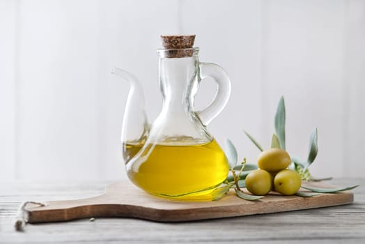 Organic olive oil. Bottle of Extra virgin oil with olives and branch leaves