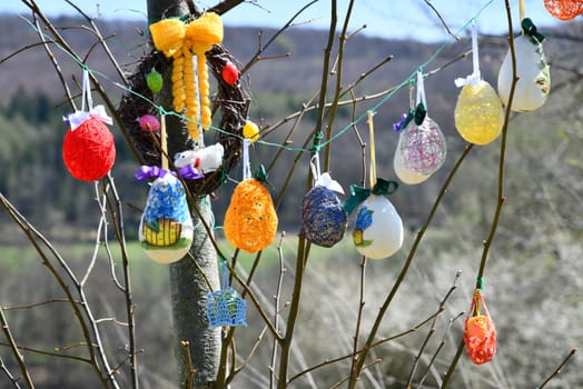Rural woman decorate an Easter tree