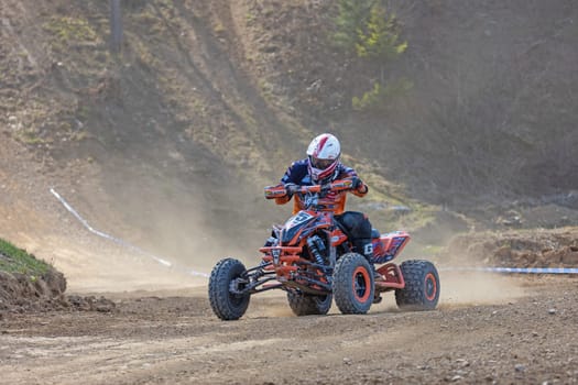 MOHELNICE,  CZECH REPUBLIC - APRIL 16, 2022: Young rider on a quad bike is  passing turn in International Championship of Czech Republic in Sidecarcross, category Quad on April 16, 2022 in Mohelnice.