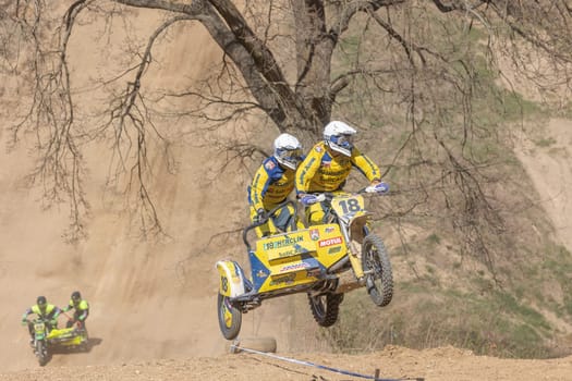 MOHELNICE, CZECH REPUBLIC - APRIL 16, 2022. Racers in yellow rides a sidecar in the "Sidecarcross Championship of Czech Republic"" on April 16, 2022 in the town of Mohelnice, Czech Republic"