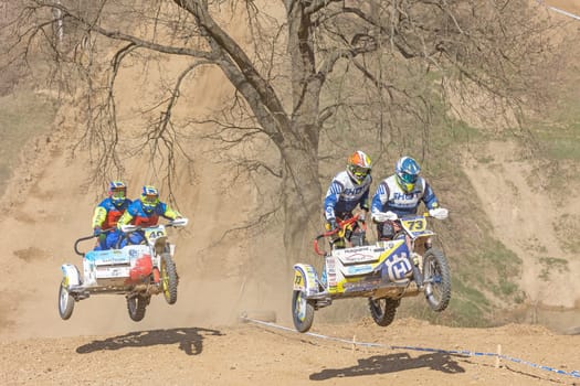 MOHELNICE, CZECH REPUBLIC - APRIL 16, 2022. Two crews of sidecacross motorbike are jumping together in the "Sidecarcross Championship of Czech Republic"" on April 16, 2022 in the town of Mohelnice."