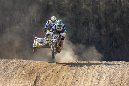 MOHELNICE, CZECH REPUBLIC - APRIL 16, 2022. Riders Hlava and Hrachovec are jumping with motorbike in the "Sidecarcross Championship of Czech Republic"" on April 16, 2022 in Mohelnice. Czech Republic."