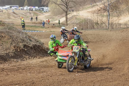 MOHELNICE, CZECH REPUBLIC - APRIL 16, 2022. Two sidecarcross bike in the turn in difficult terrain in the "Sidecarcross Championship of Czech Republic"" on April 16, 2022 in the town of Mohelnice. CR"