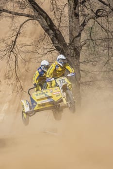 MOHELNICE, CZECH REPUBLIC - APRIL 16, 2022. Riders are in a high jump over the amount of dust in the "Sidecarcross Championship of Czech Republic"" on April 16, 2022 in the town of Mohelnice."
