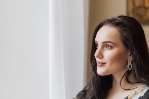 Side view portrait of atractive dark haired young woman. Horizontally.